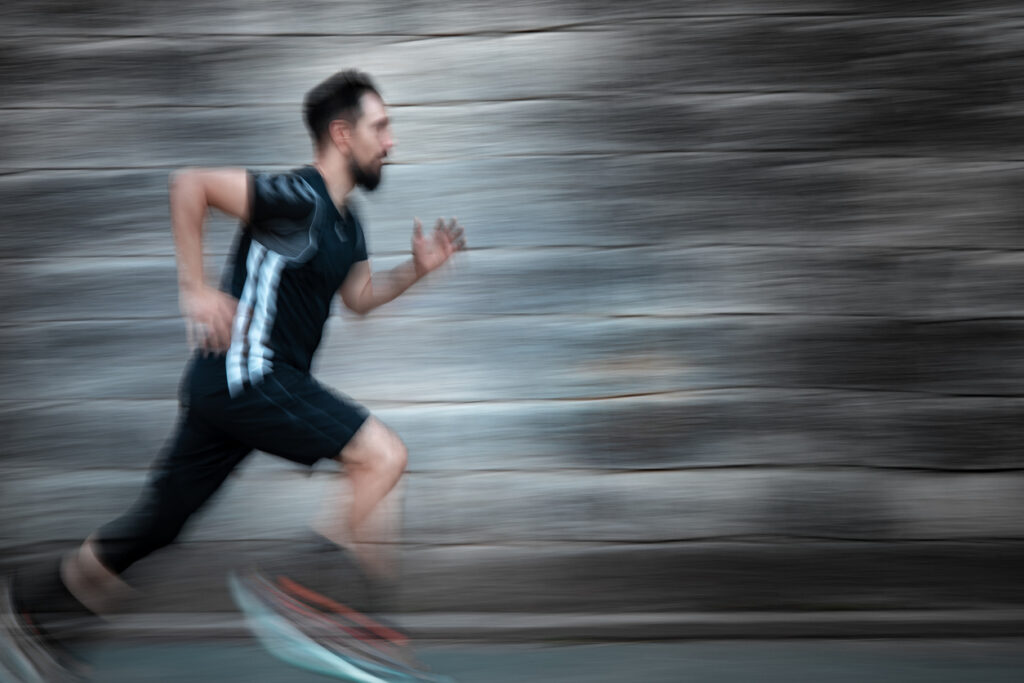 Motivated man sprinting , embracing fitness and recreational sports with passion